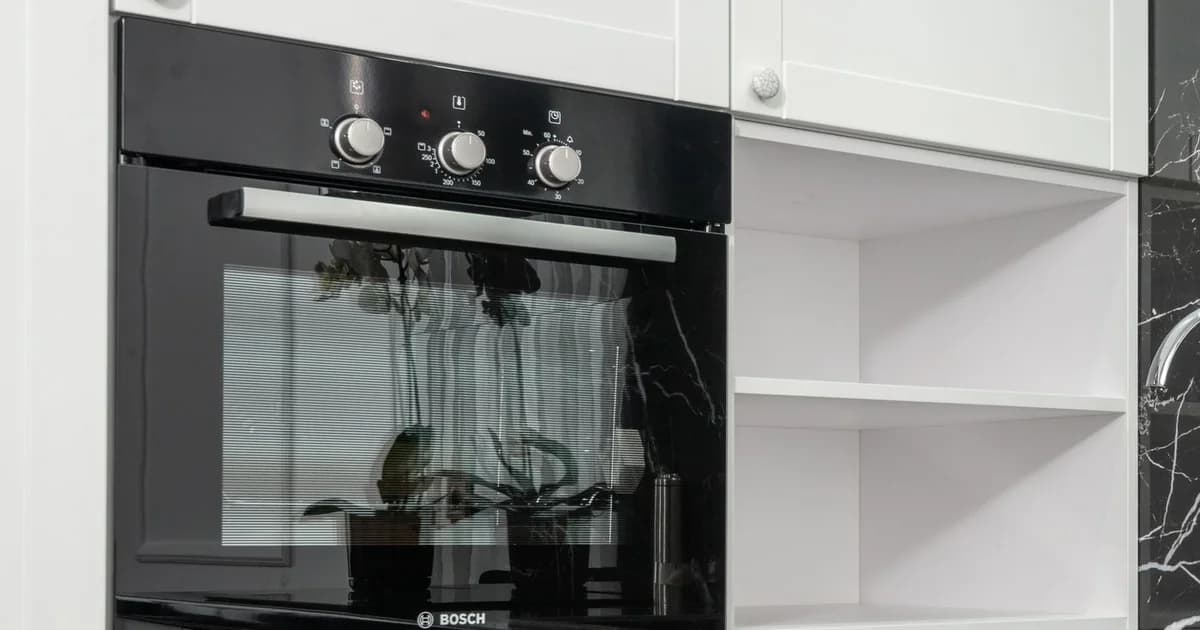 Built-in oven with a clean glass door in a fitted kitchen